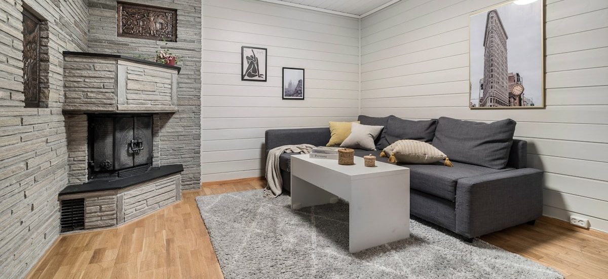 A living room filled with furniture and a fire place